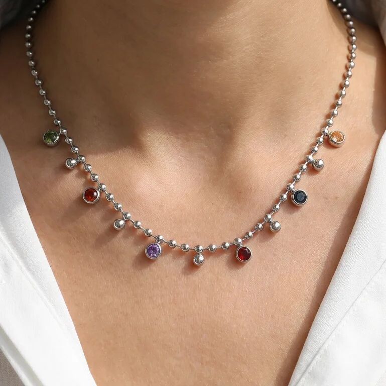 Necklace with colorful beads on a person wearing a white shirt