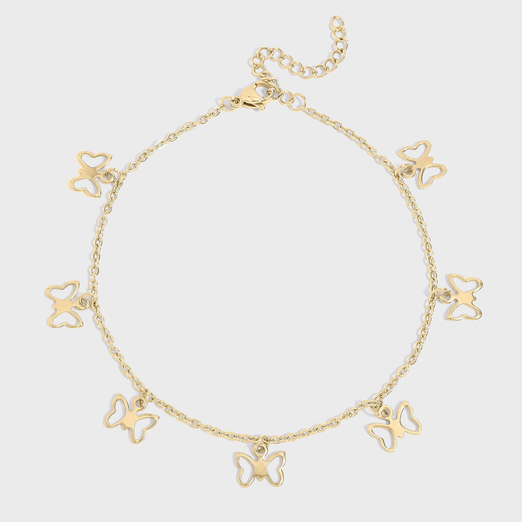 Gold butterfly charm anklet on a light gray background