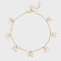 Gold butterfly charm anklet on a light gray background