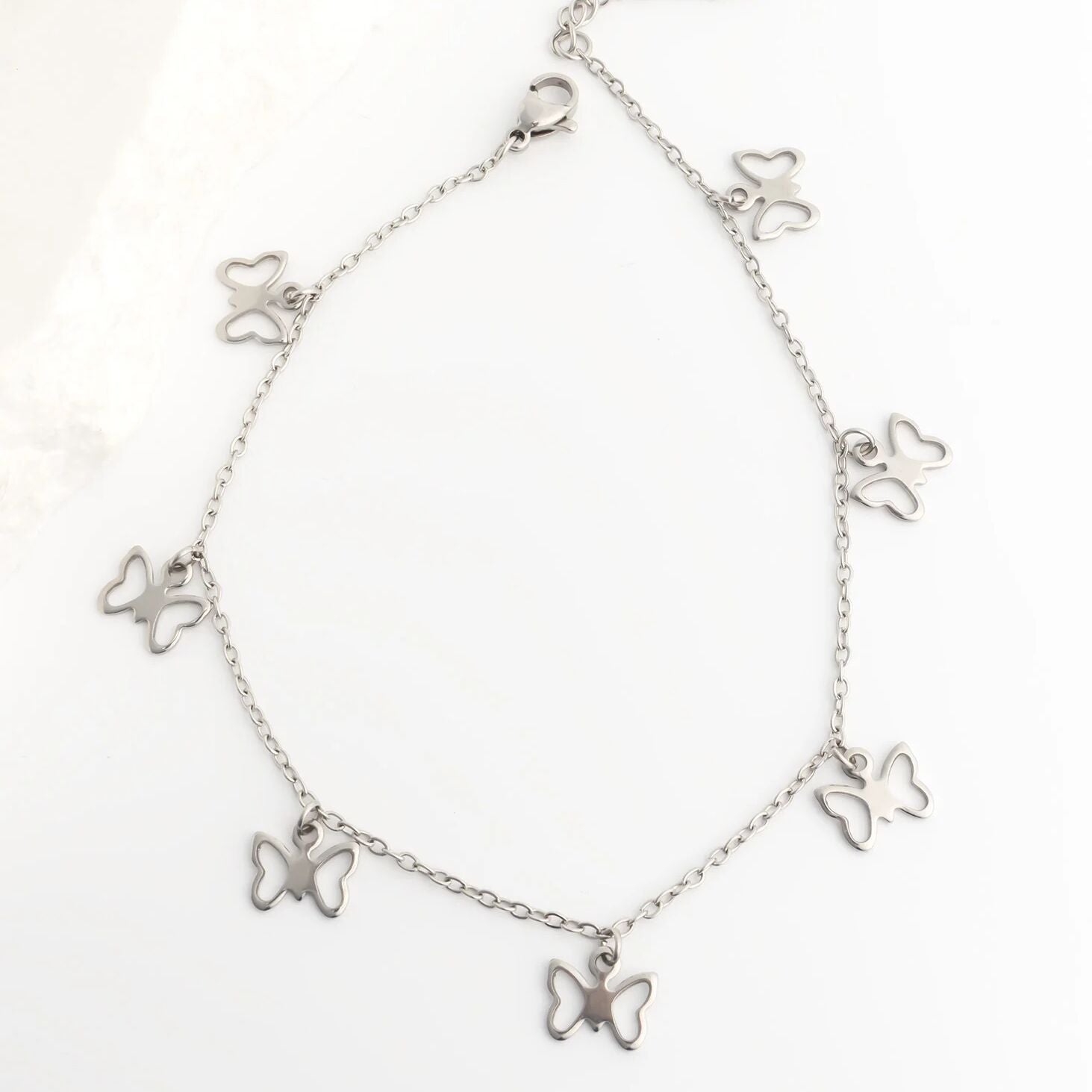 Silver butterfly bracelet on a white background