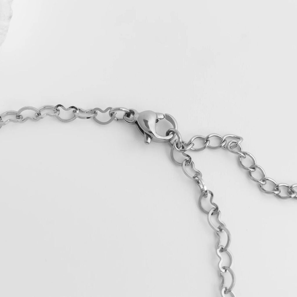 Silver chain Linked Hearts Anklet on a light gray background
