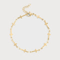 Gold bracelet with cross designs on a light gray background