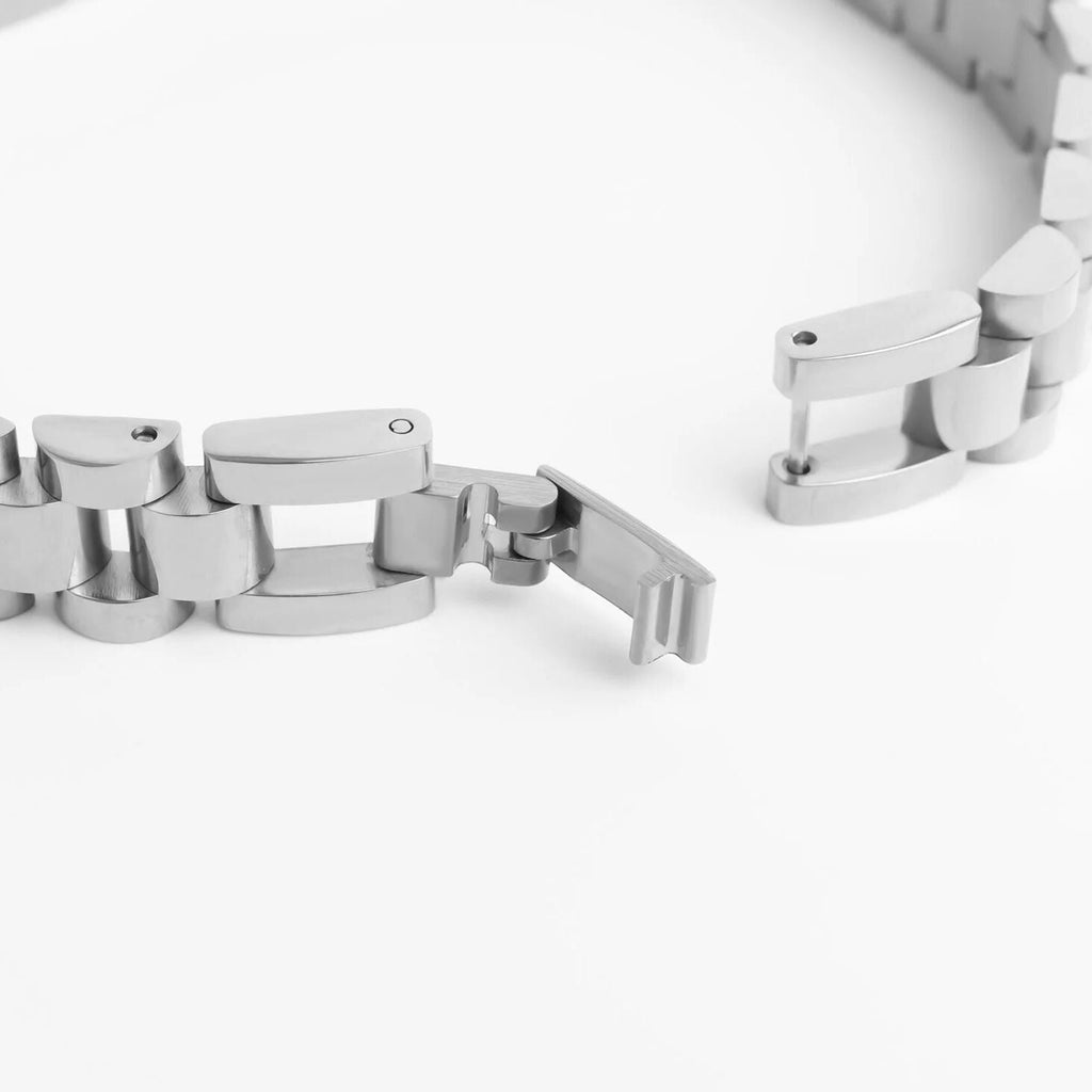 Close-up of a silver metal bracelet on a white background