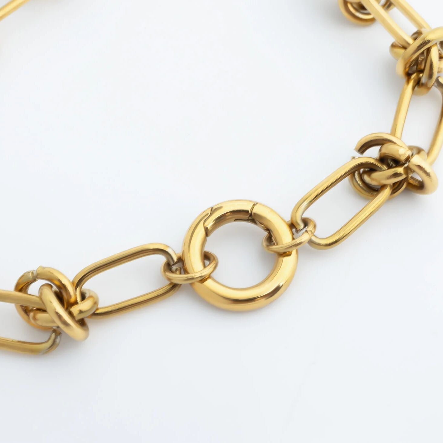 Gold chain bracelet on a white background