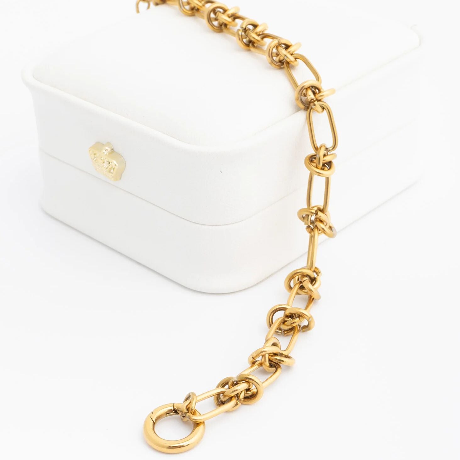 Gold chain bracelet on a white background
