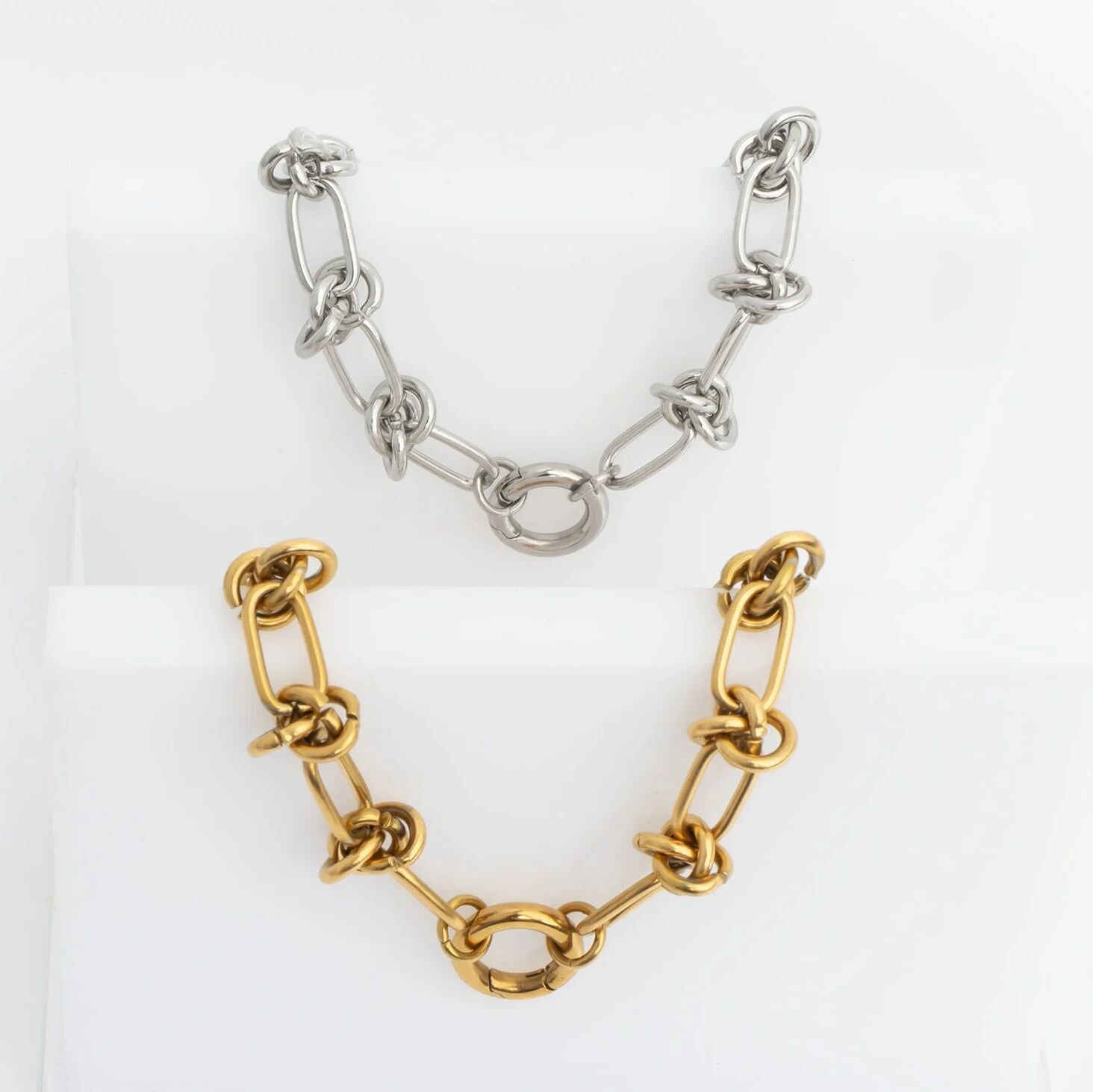 Gold and silver chain bracelets on a white background