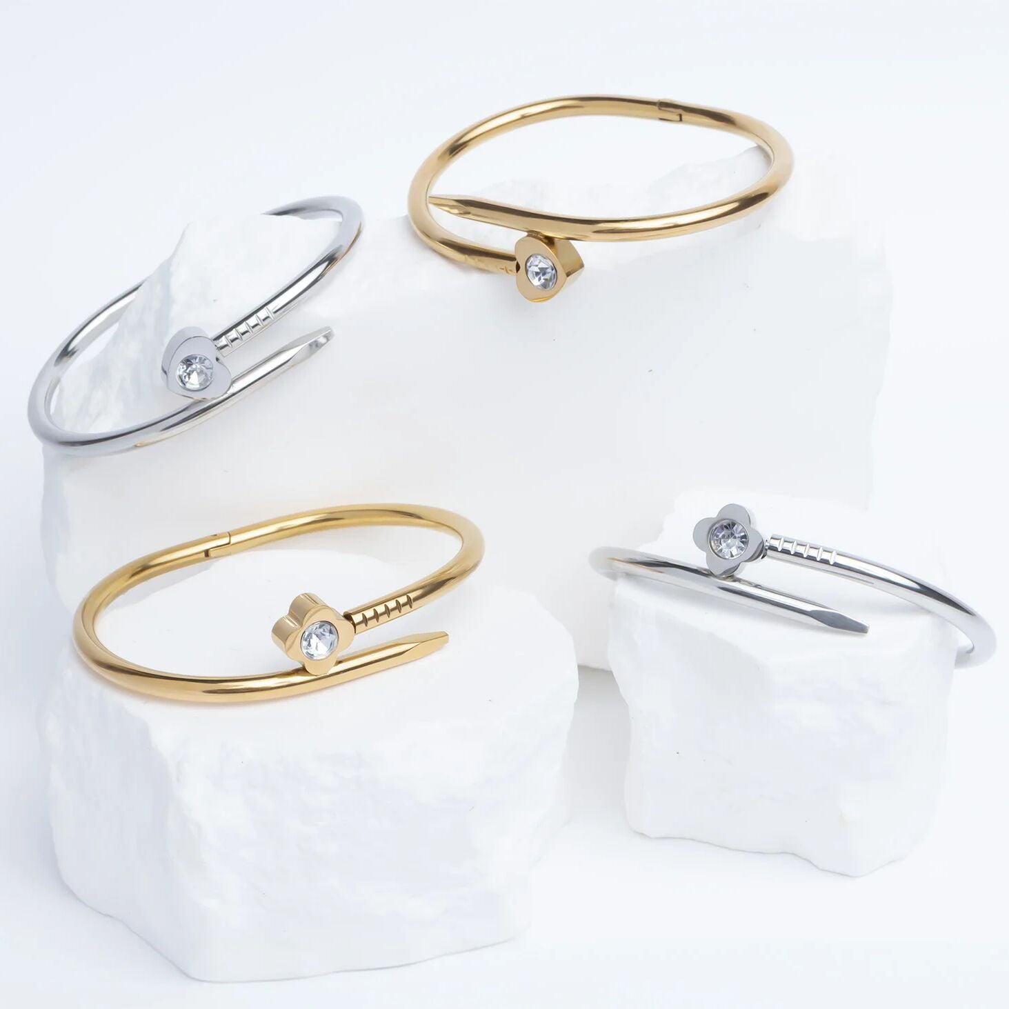 Set of gold and silver bangle bracelets on a white background
