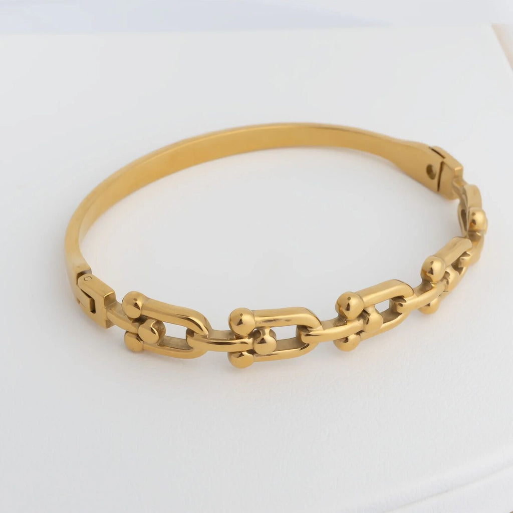 Gold chain bracelet on a white background