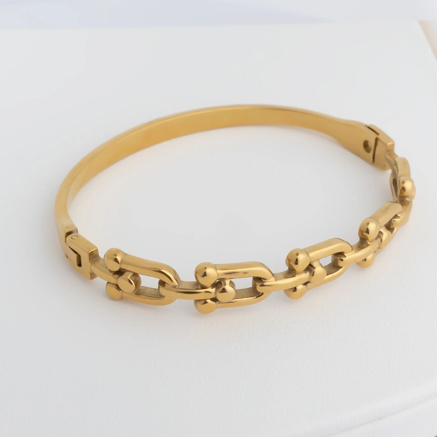 Gold chain bracelet on a white background