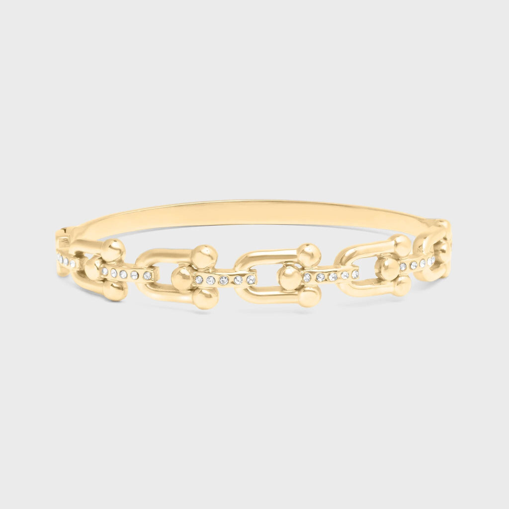 Gold chain bracelet on a light gray background