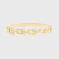 Gold chain bracelet on a light gray background