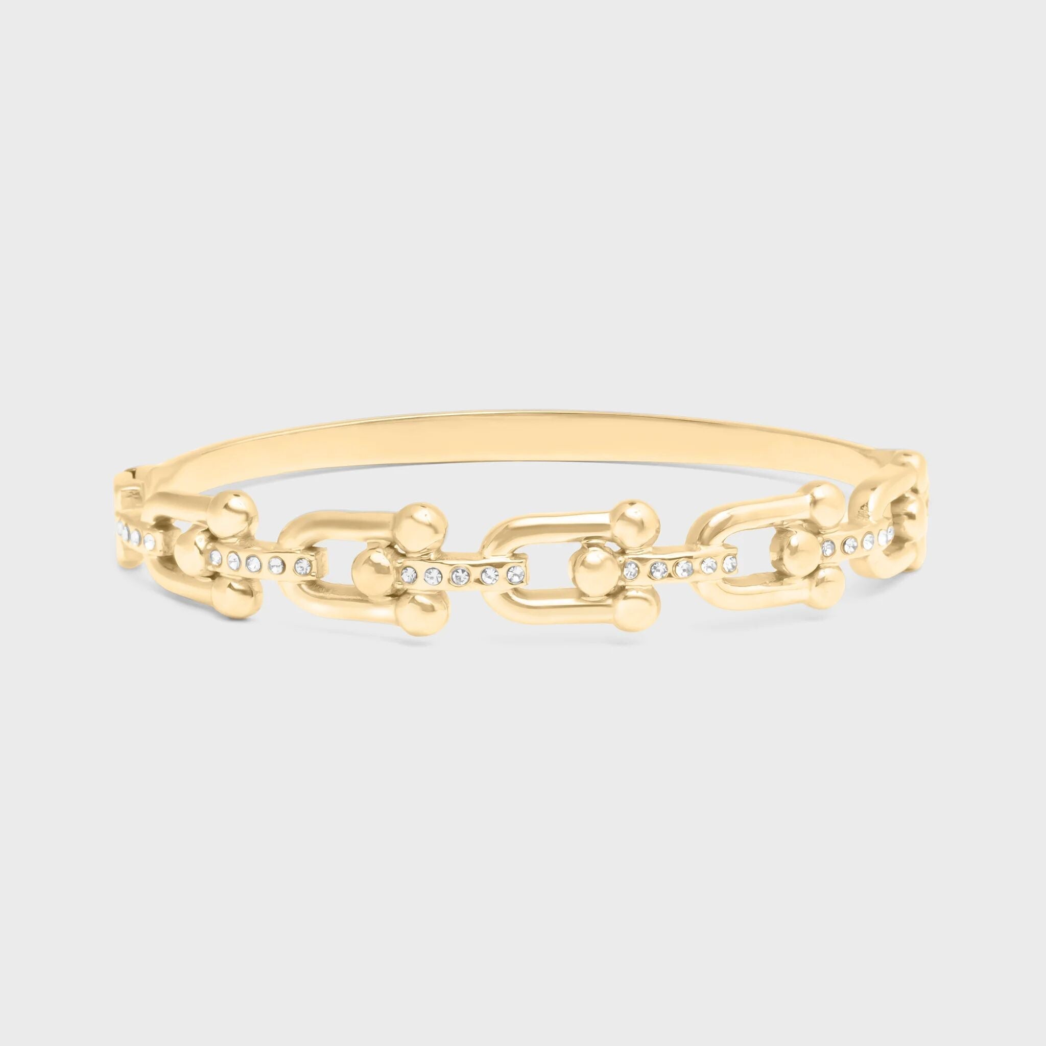 Gold chain bracelet on a light gray background