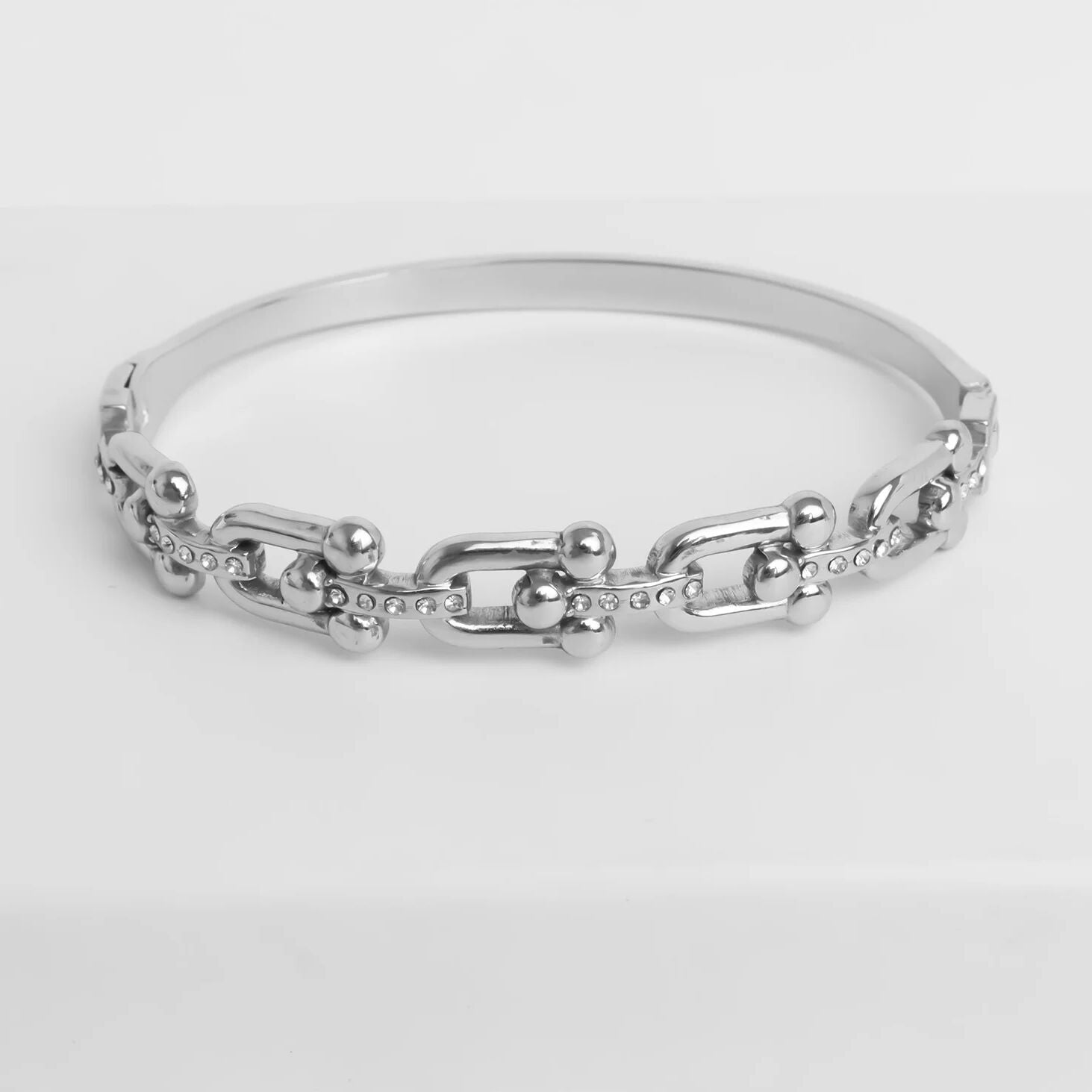 Silver chain bracelet on a light gray background