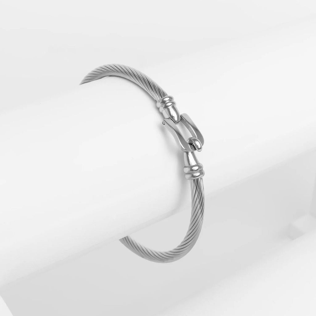Silver bracelet with tassel on a light gray background