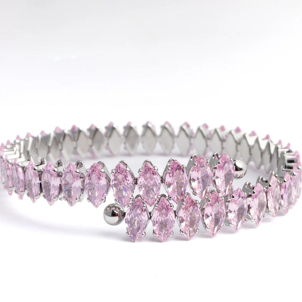 Silver tiara with pink gemstones on a white background