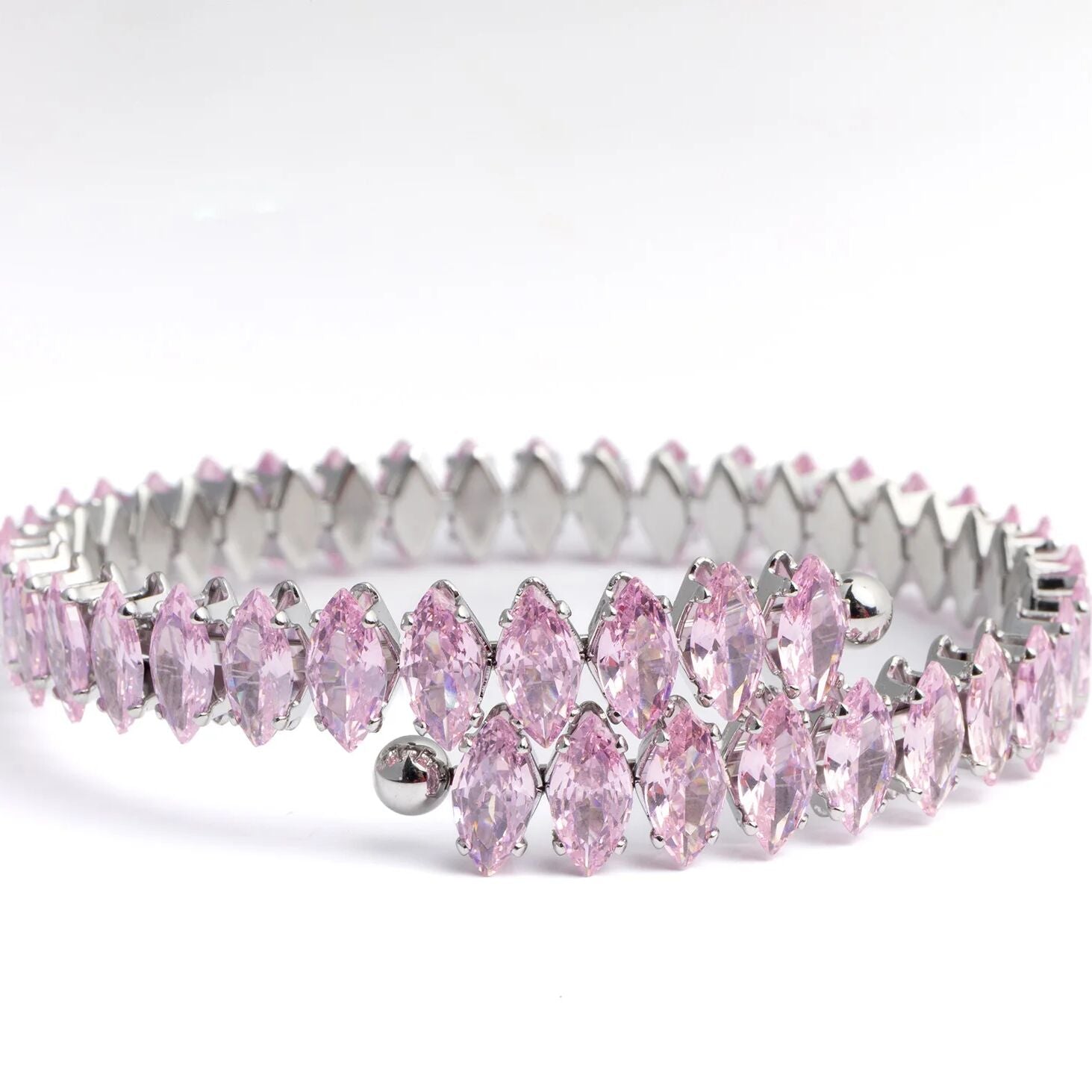 Silver tiara with pink gemstones on a white background