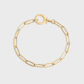 Gold chain bracelet on a light gray background