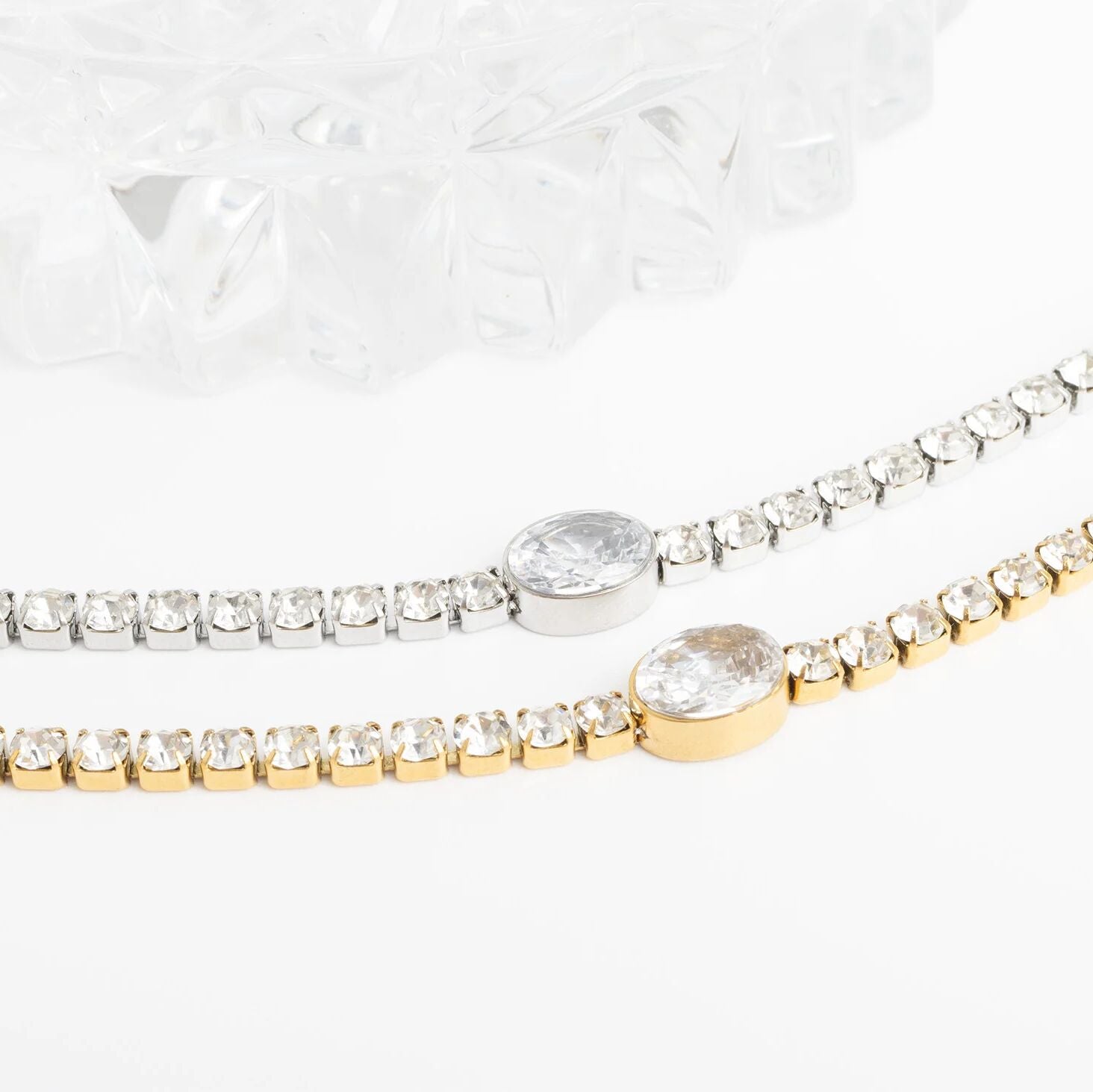 Two diamond bracelets on a white background