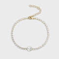 Gold bracelet with clear gemstones on a light gray background