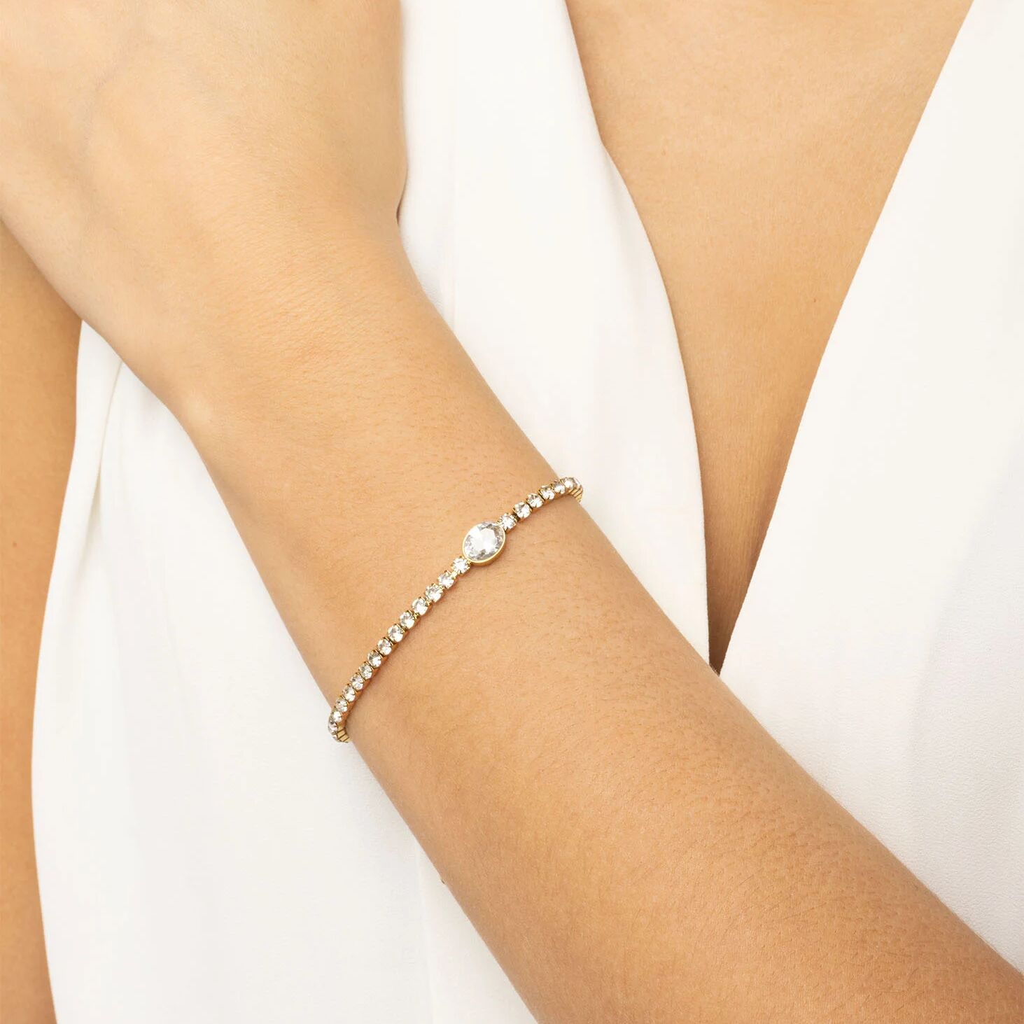 Pearl bracelet on a person's wrist against a white background