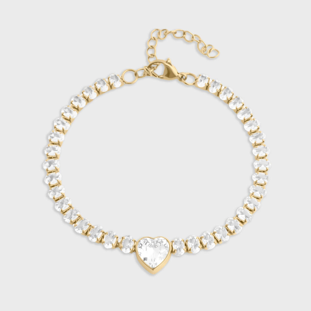 Gold and crystal bracelet on a light gray background