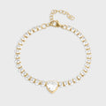 Gold and crystal bracelet on a light gray background