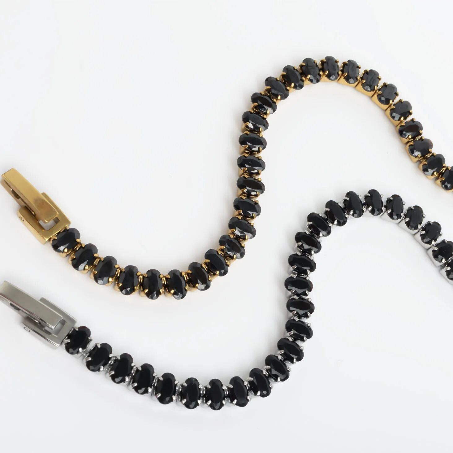 Black beaded zipper pull with gold accents on a white background