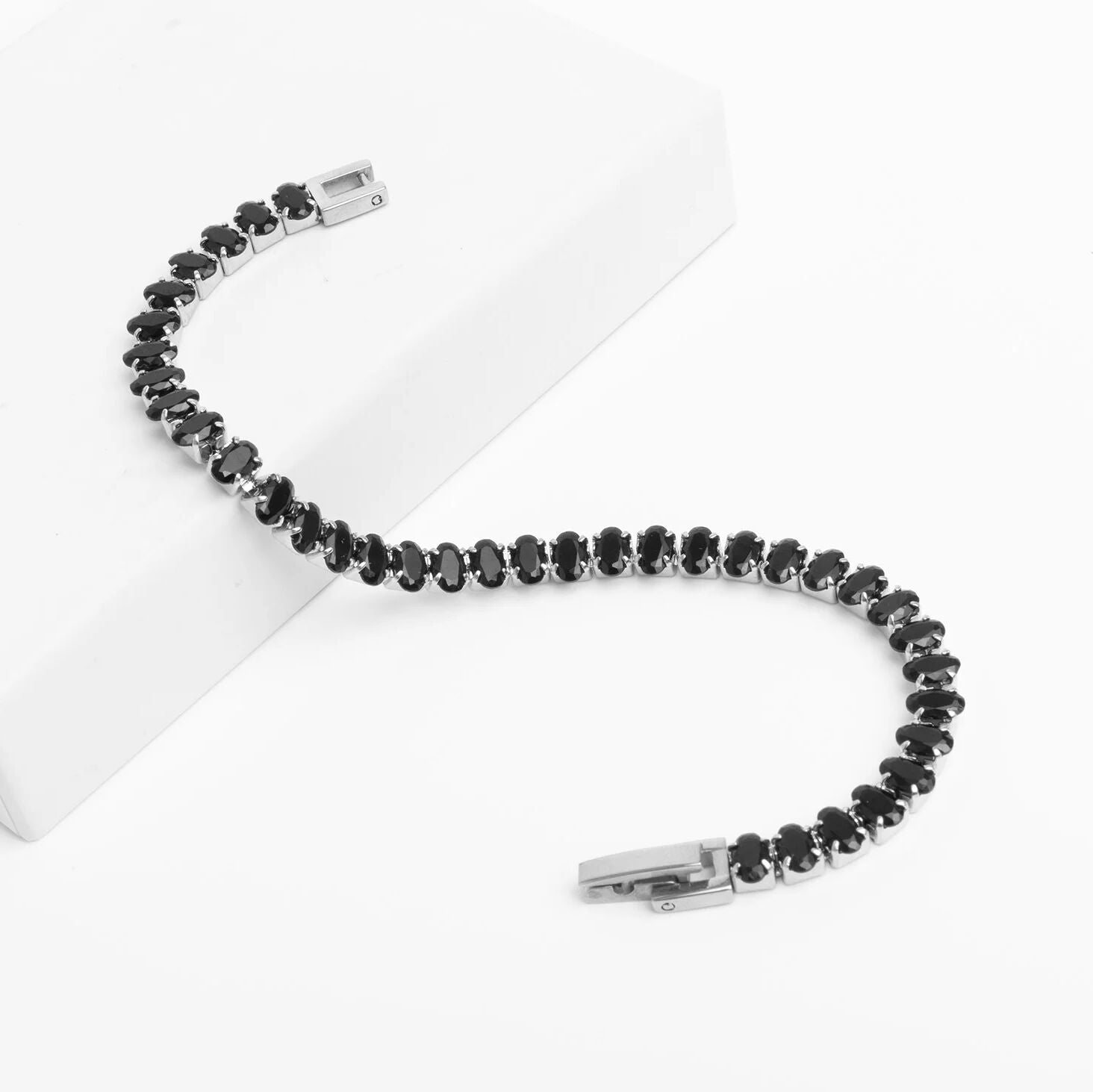 Black beaded bracelet with silver clasp on a white background