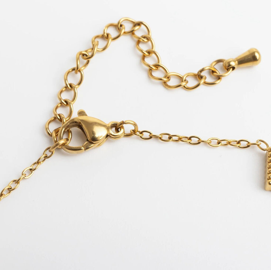 Gold chain bracelet on a white background