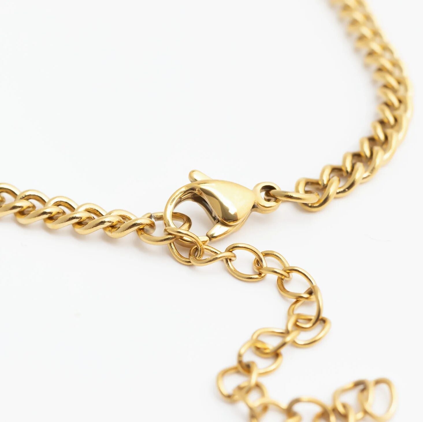 Gold chain bracelet on a white background