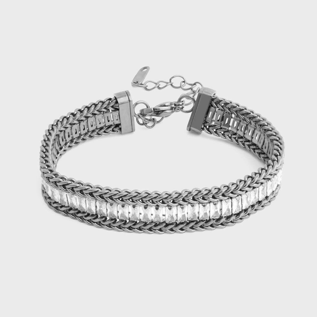 Silver bracelet with braided design on a light gray background