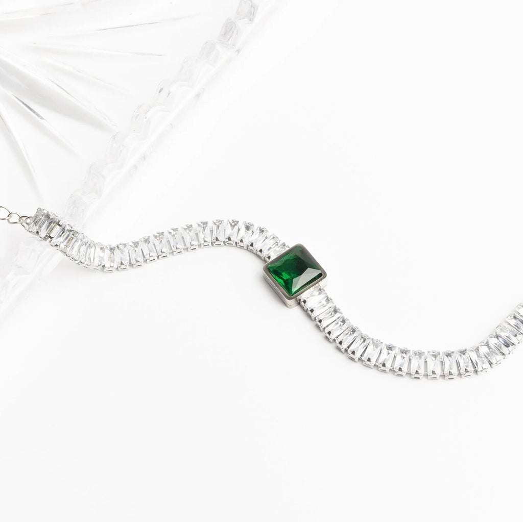 Necklace with a green gemstone on a white background