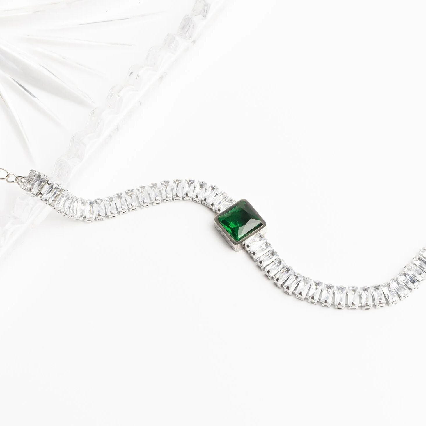 Necklace with a green gemstone on a white background