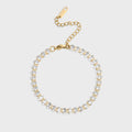 Gold and silver beaded bracelet on a light gray background