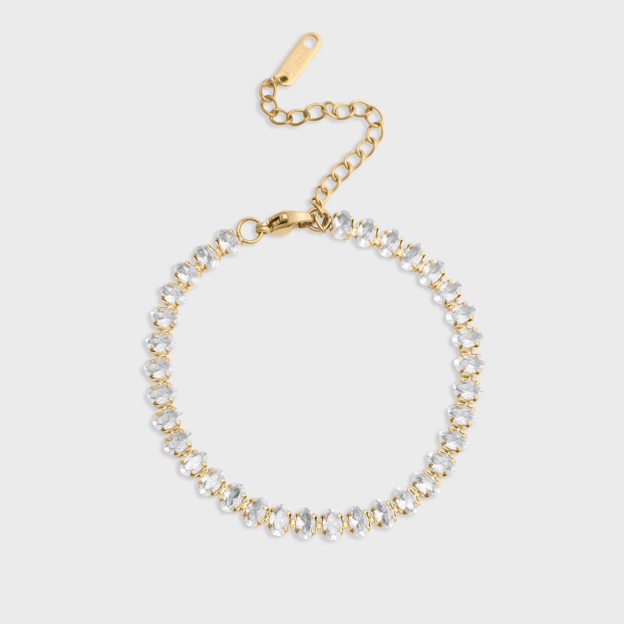 Gold and silver beaded bracelet on a light gray background