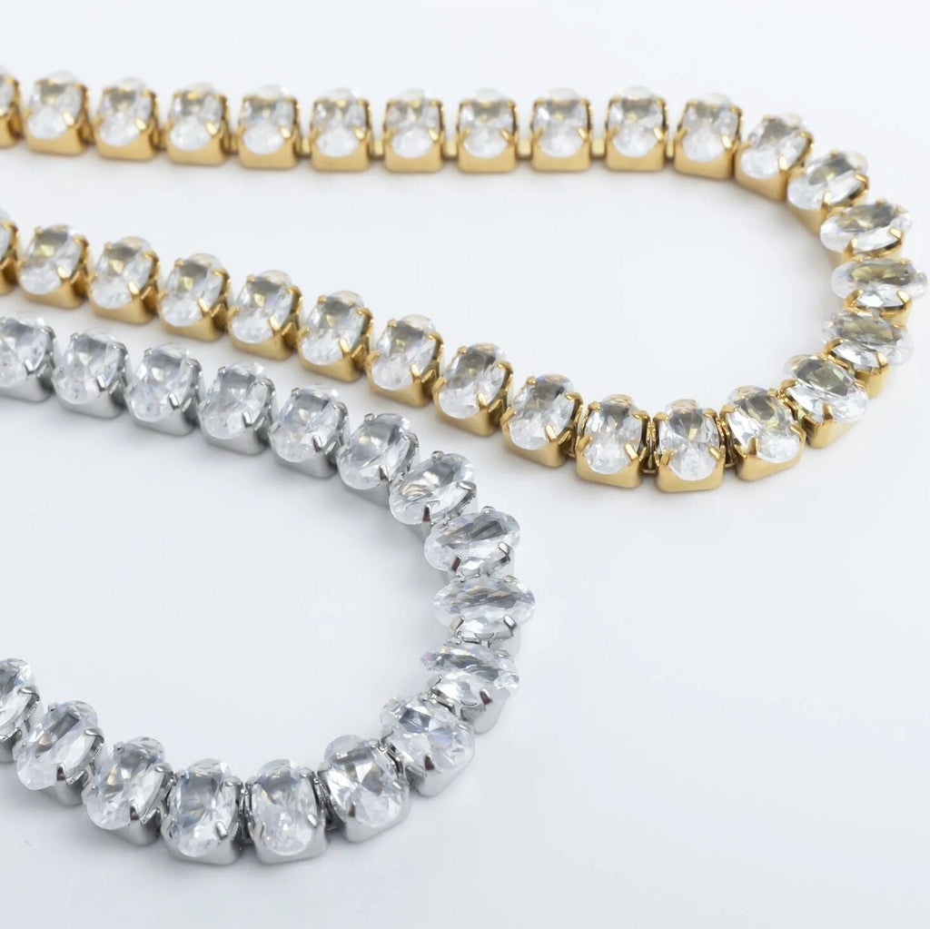 Two gold and silver beaded bracelets on a white background