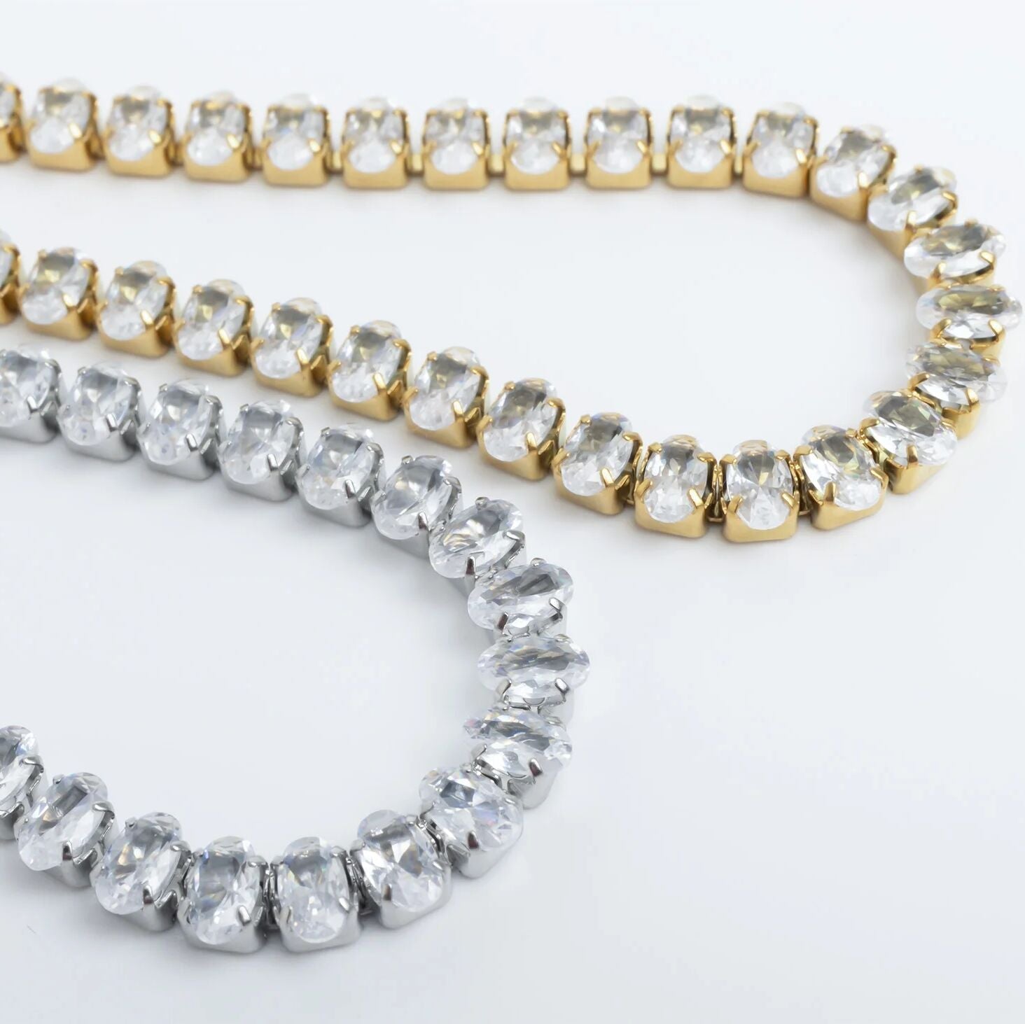 Two gold and silver beaded bracelets on a white background