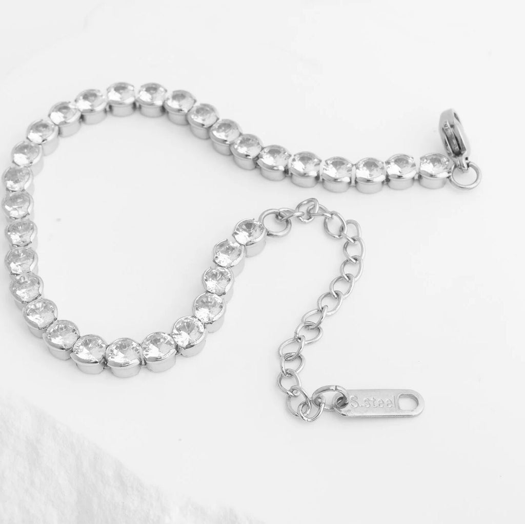 Silver bracelet with clear stones on a white background