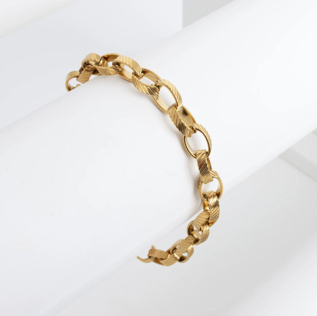 Gold chain bracelet on a white background
