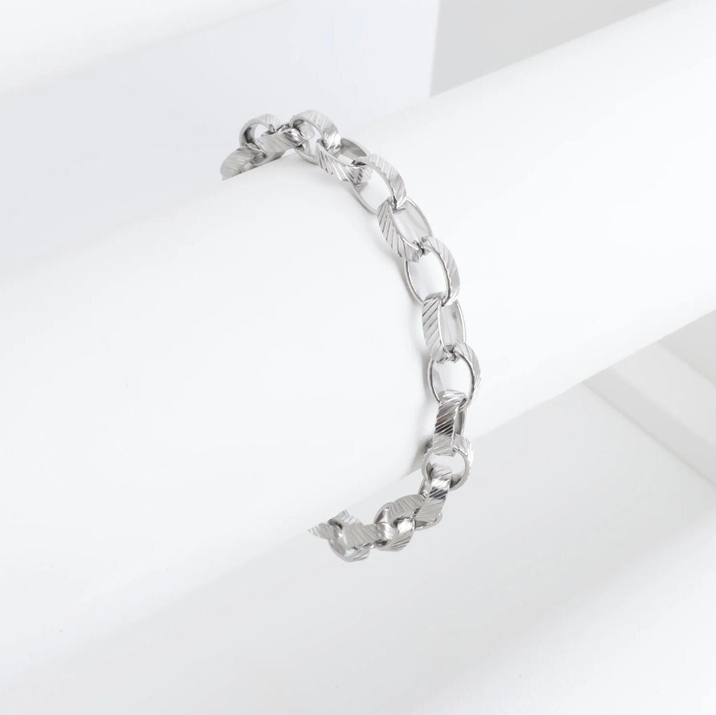Silver chain bracelet on a light gray background