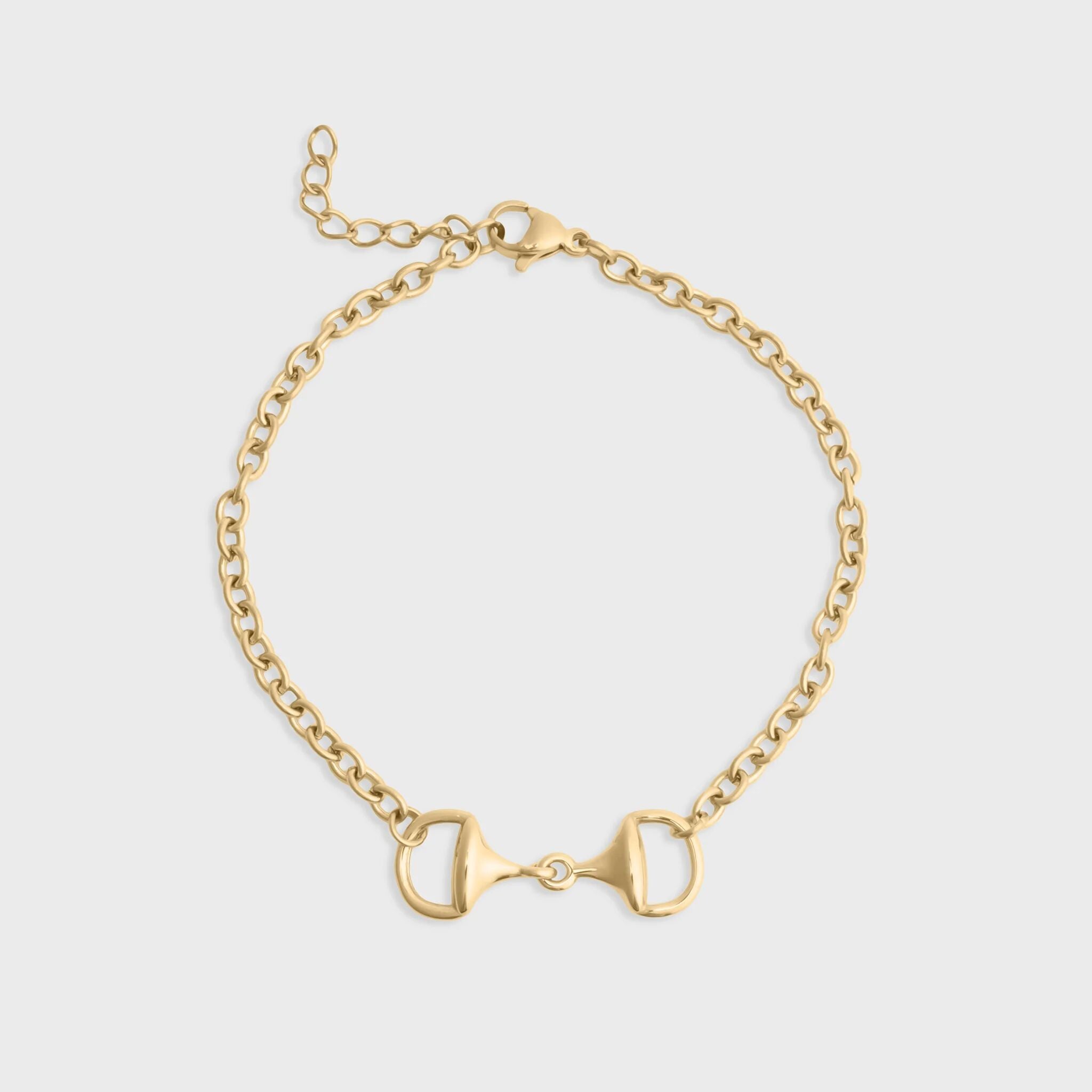 Gold bracelet with a horse bit design on a light gray background