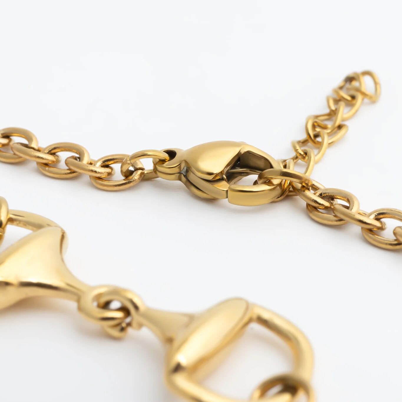 Gold chain Horsebit Bracelet with a clasp on a white background