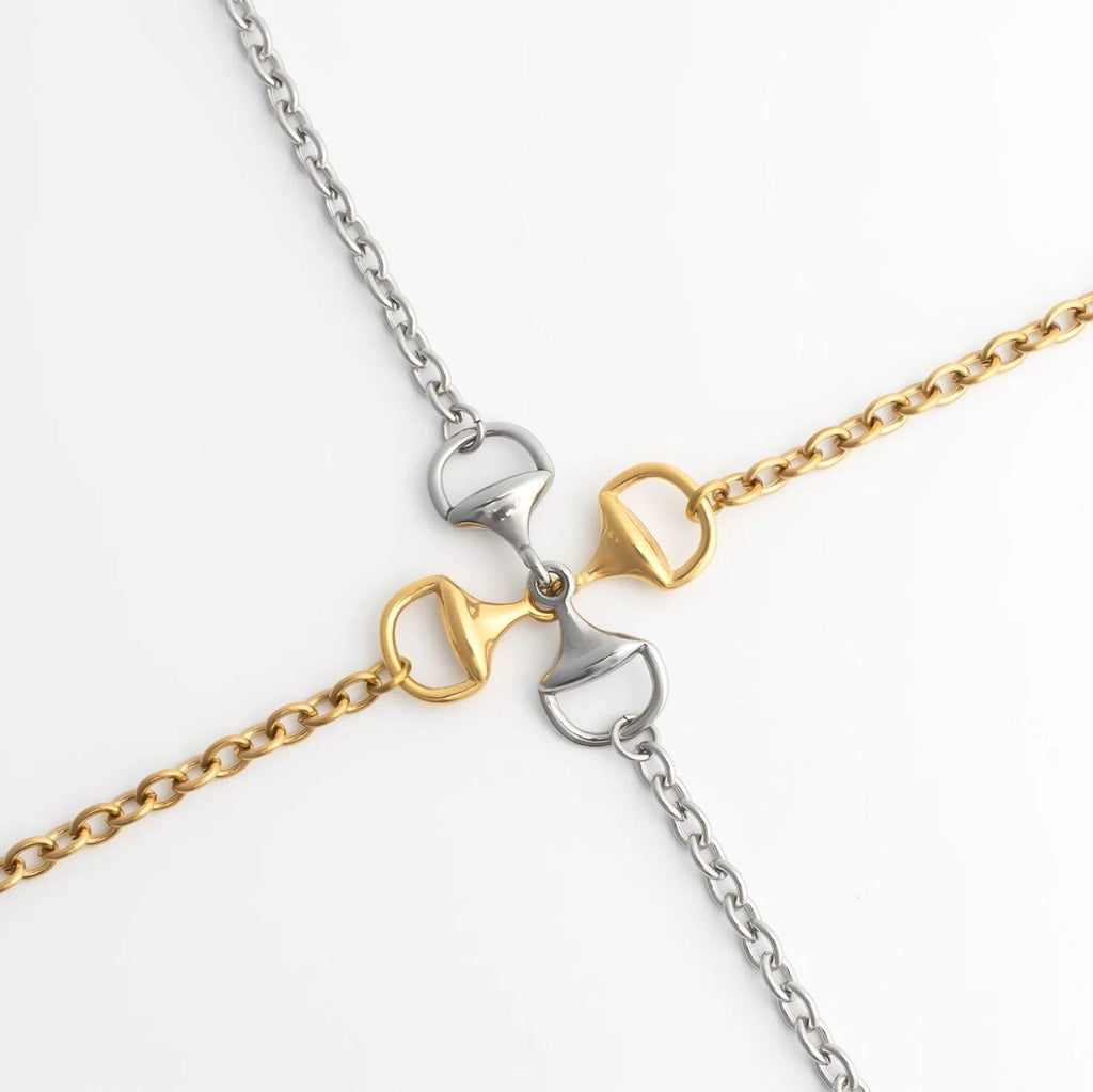 Two gold and silver chain Horsebit Bracelets on a white background
