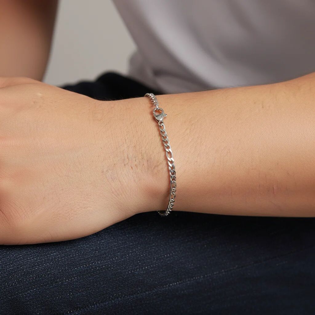 Silver bracelet on a wrist with a neutral background