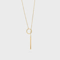 Gold necklace with circular lariat pendant on a white background