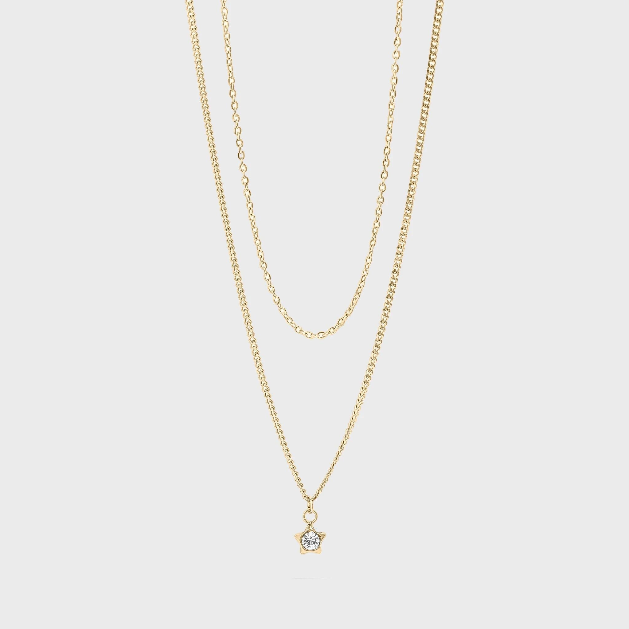 Gold necklace with a small star pendant on a light gray background
