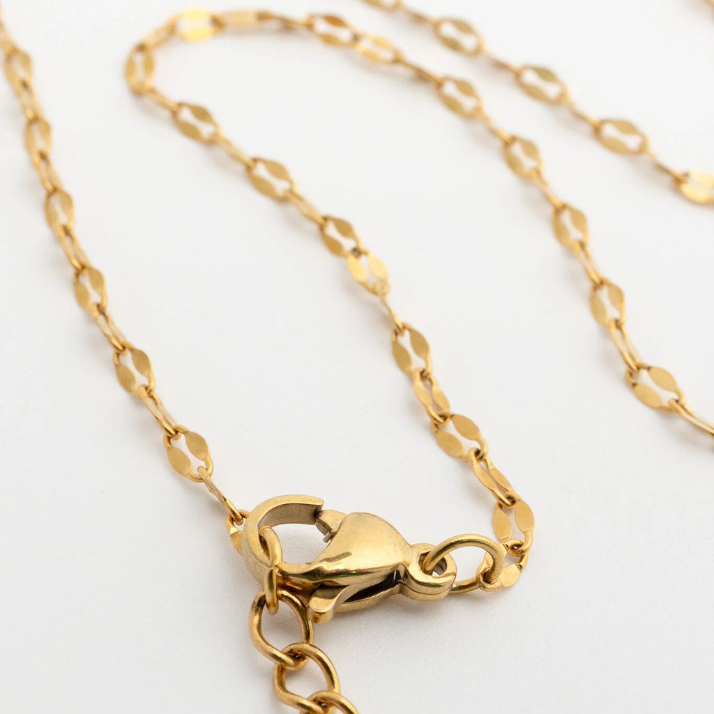 Gold Belly Lip Chain with clasp on a light gray background