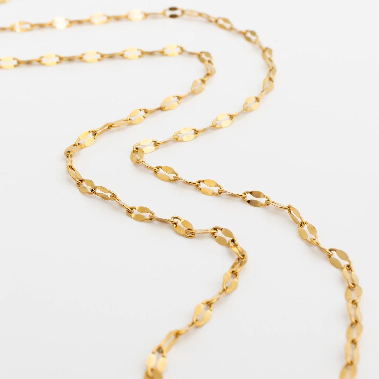 Gold Lip Belly Chain on a light gray background
