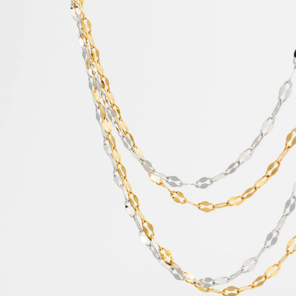 Two gold and silver Lip Belly Chains on a white background