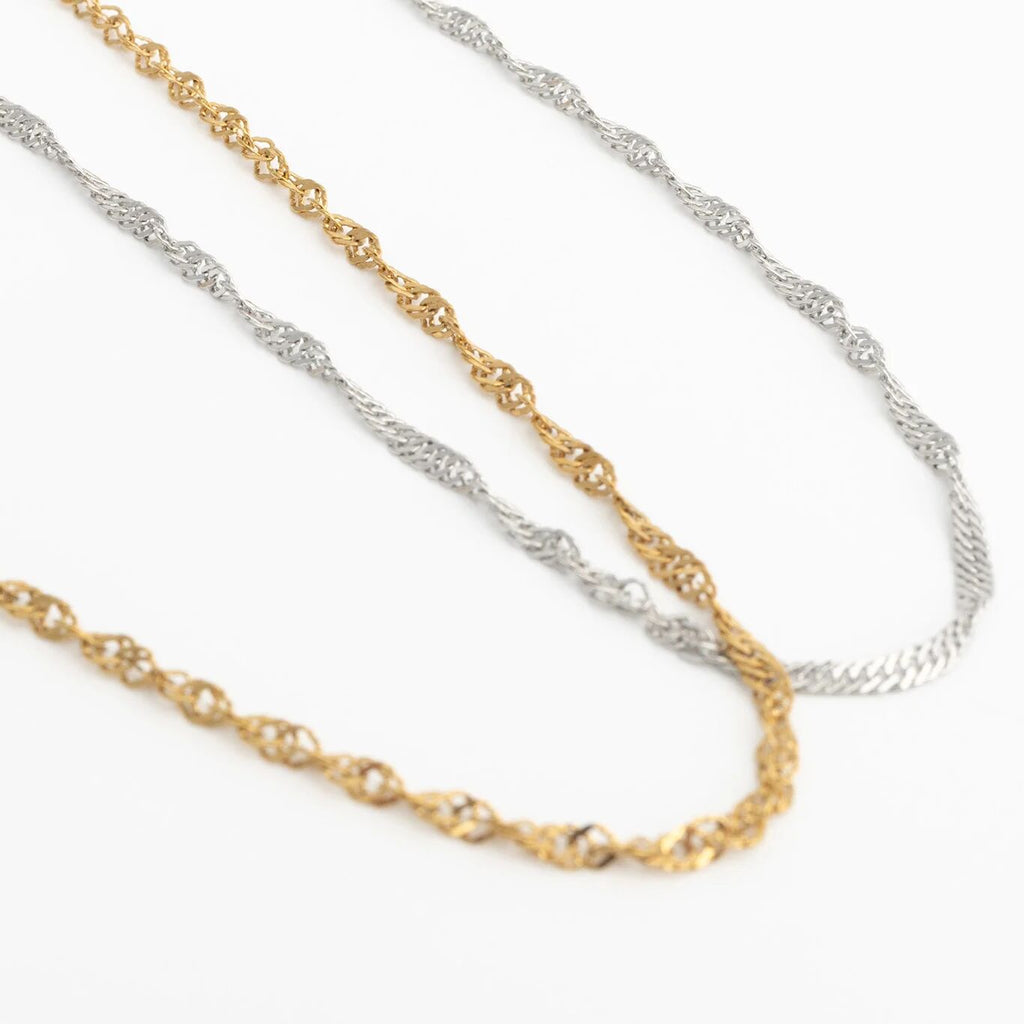 Two gold and silver Singapore Belly Chains on a white background